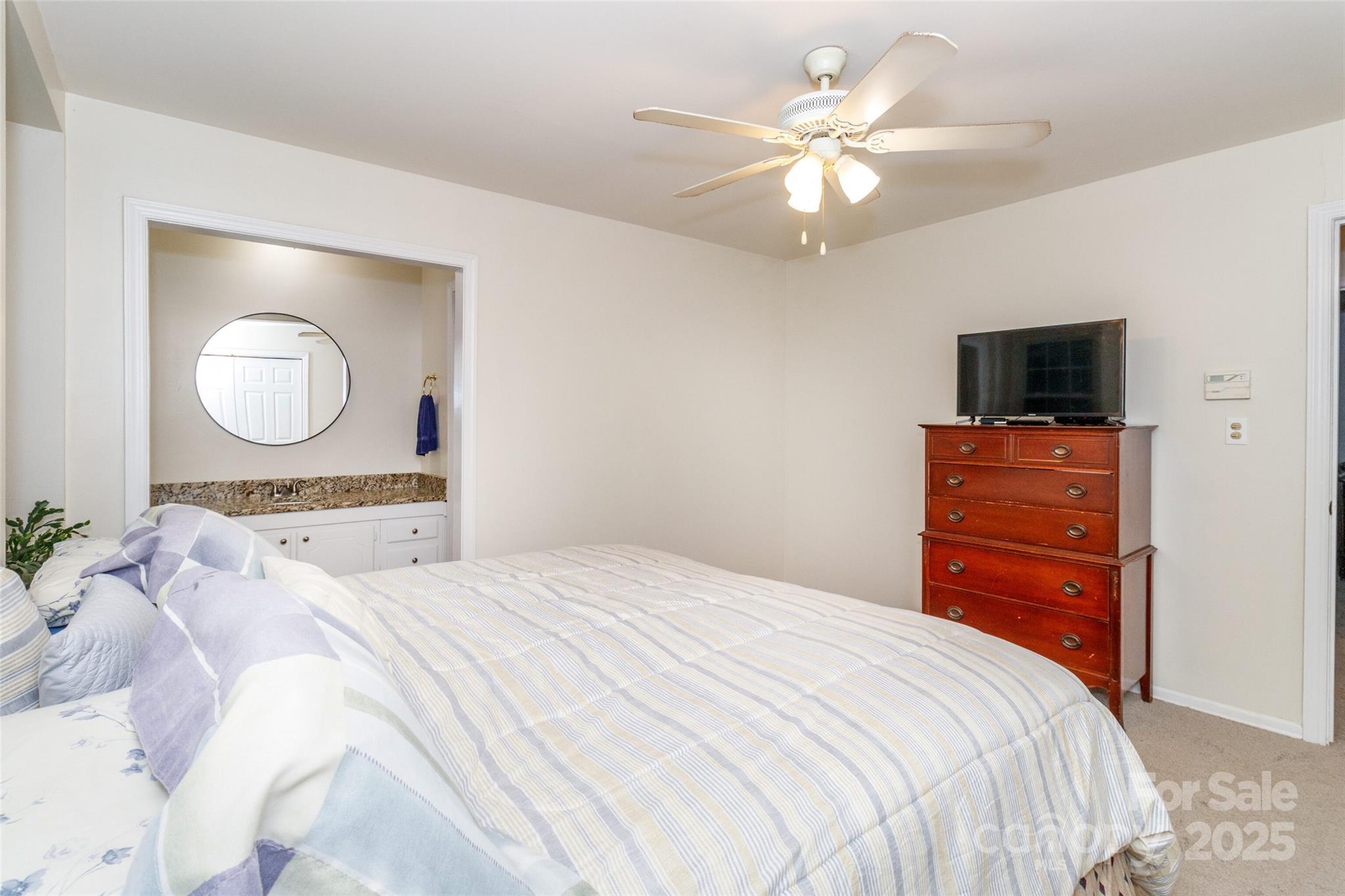 8300 Knights Bridge Road Charlotte, NC 28210 - Photo 29 of 47 a bedroom with a bed and a flat screen tv