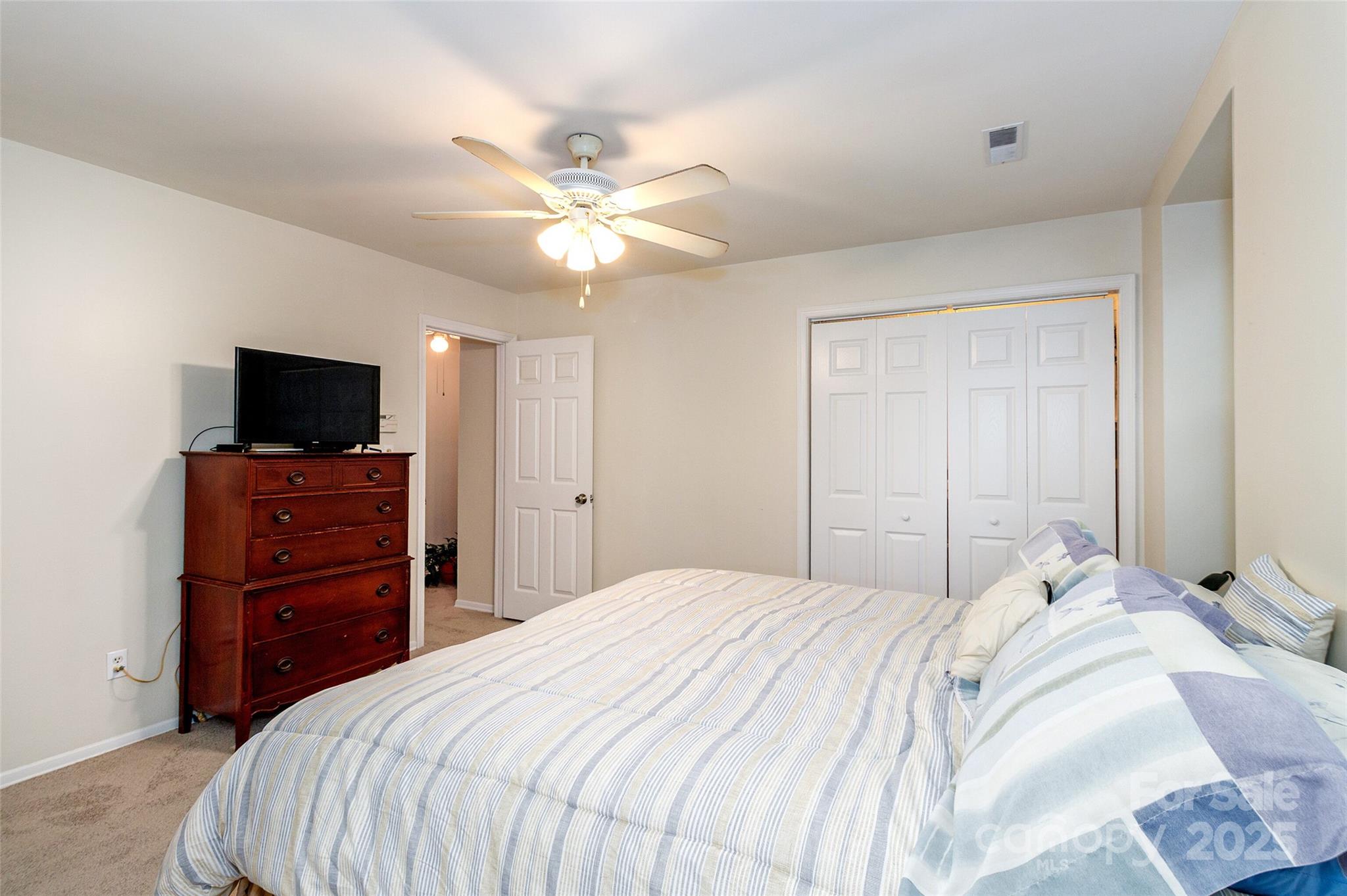 8300 Knights Bridge Road Charlotte, NC 28210 - Photo 30 of 47 a bedroom with a bed and a flat screen tv