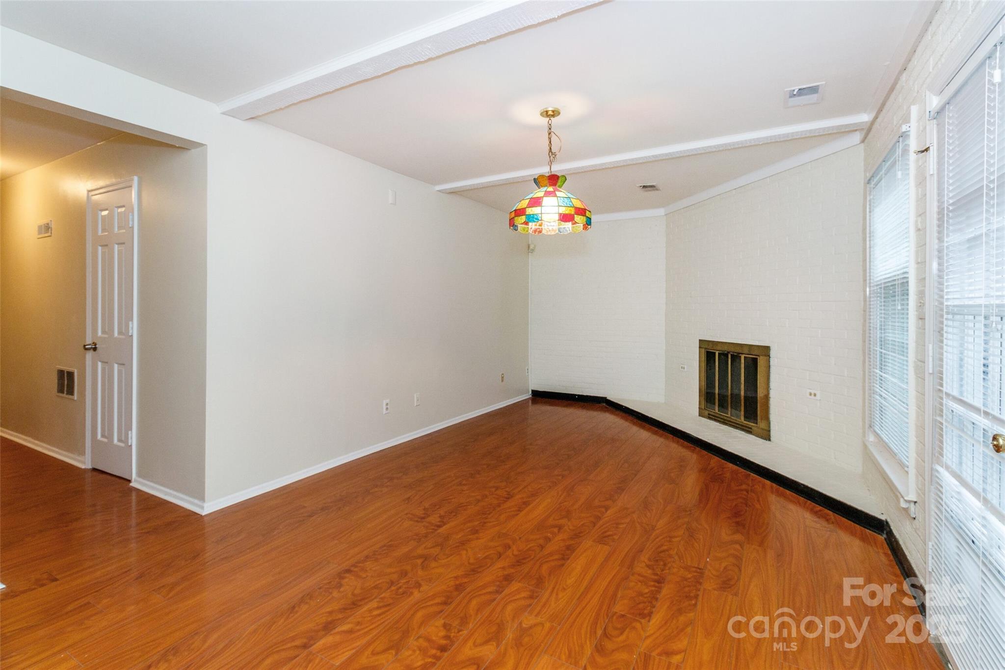 8300 Knights Bridge Road Charlotte, NC 28210 - Photo 34 of 47 a view of an empty room with a chandelier fan