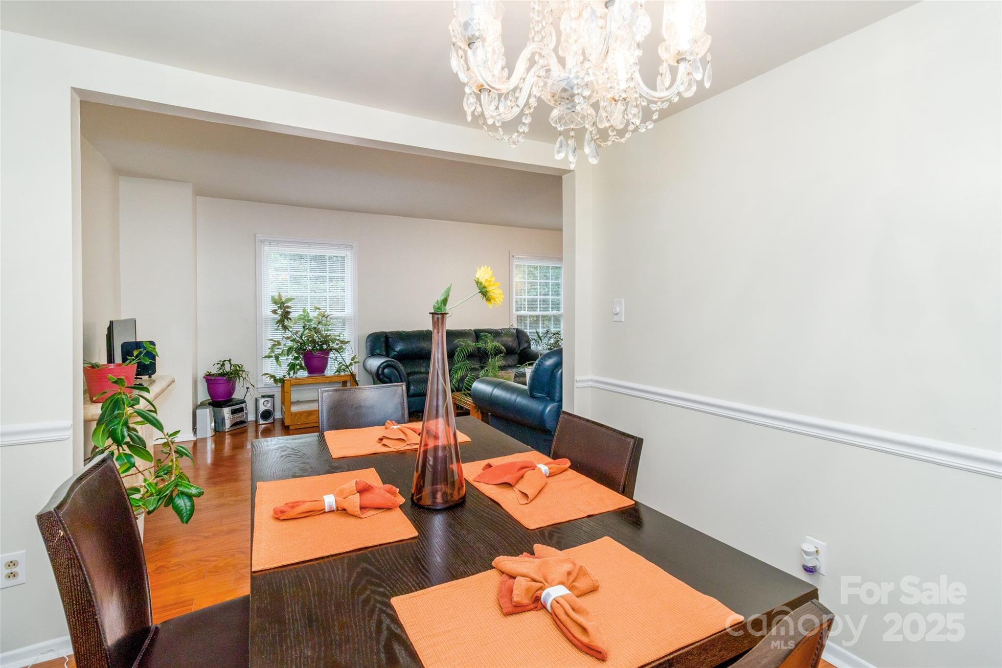 8300 Knights Bridge Road Charlotte, NC 28210 - Photo 8 of 47 a living room with furniture and a chandelier