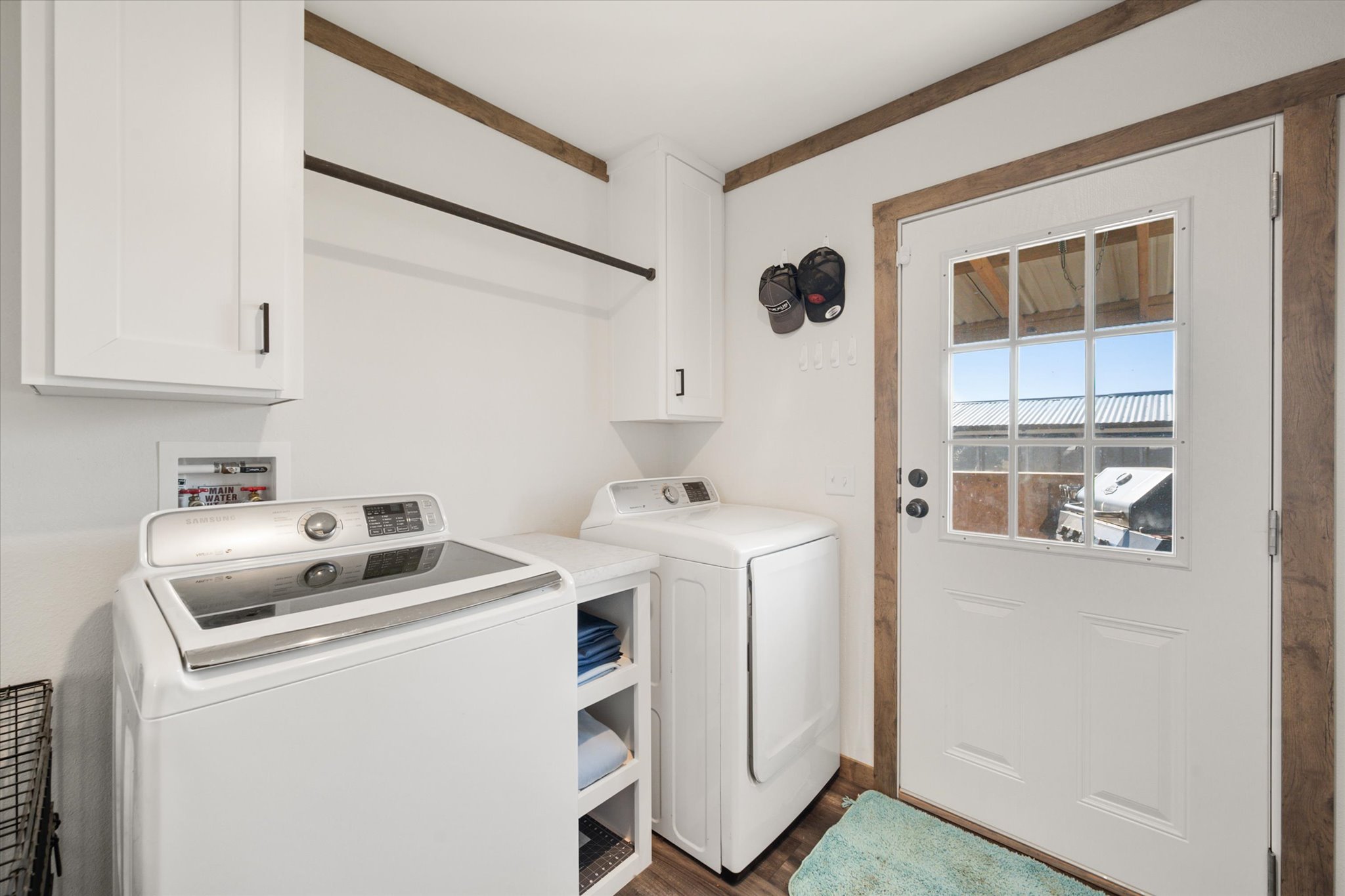 16857 Fm 639 Road East Purdon, TX 76679 - Photo 29 of 38 Washroom featuring cabinet space, washing machine and dryer, and dark wood-style floors