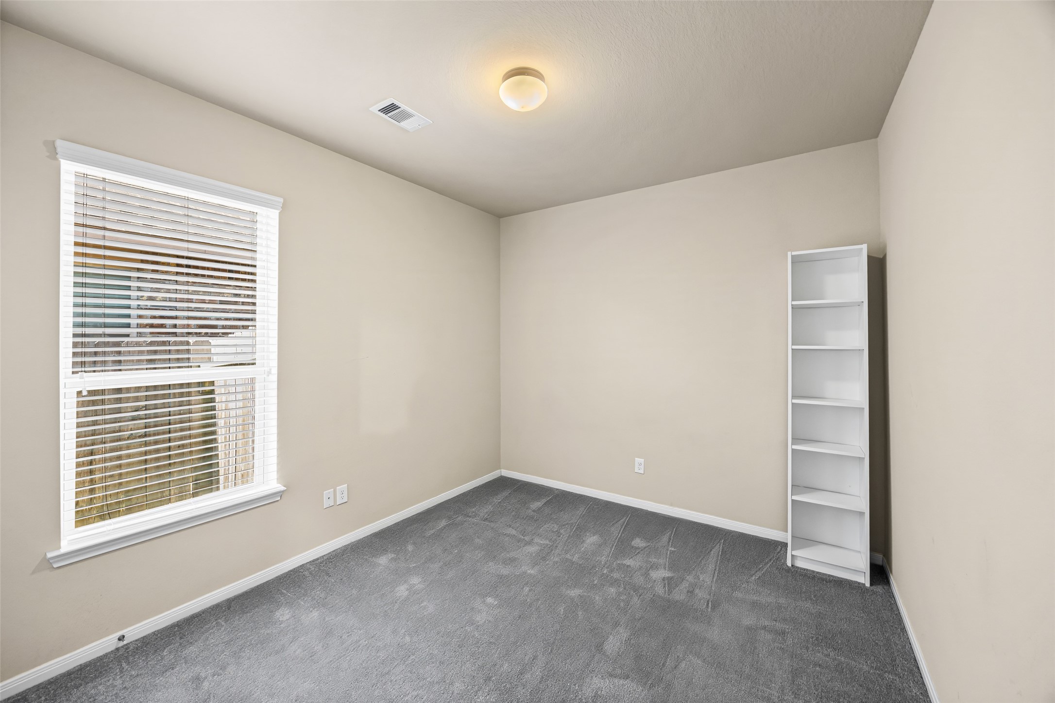 5615 Glenfield Spring Lane Spring, TX 77389 - Photo 20 of 28 a view of an empty room with a window