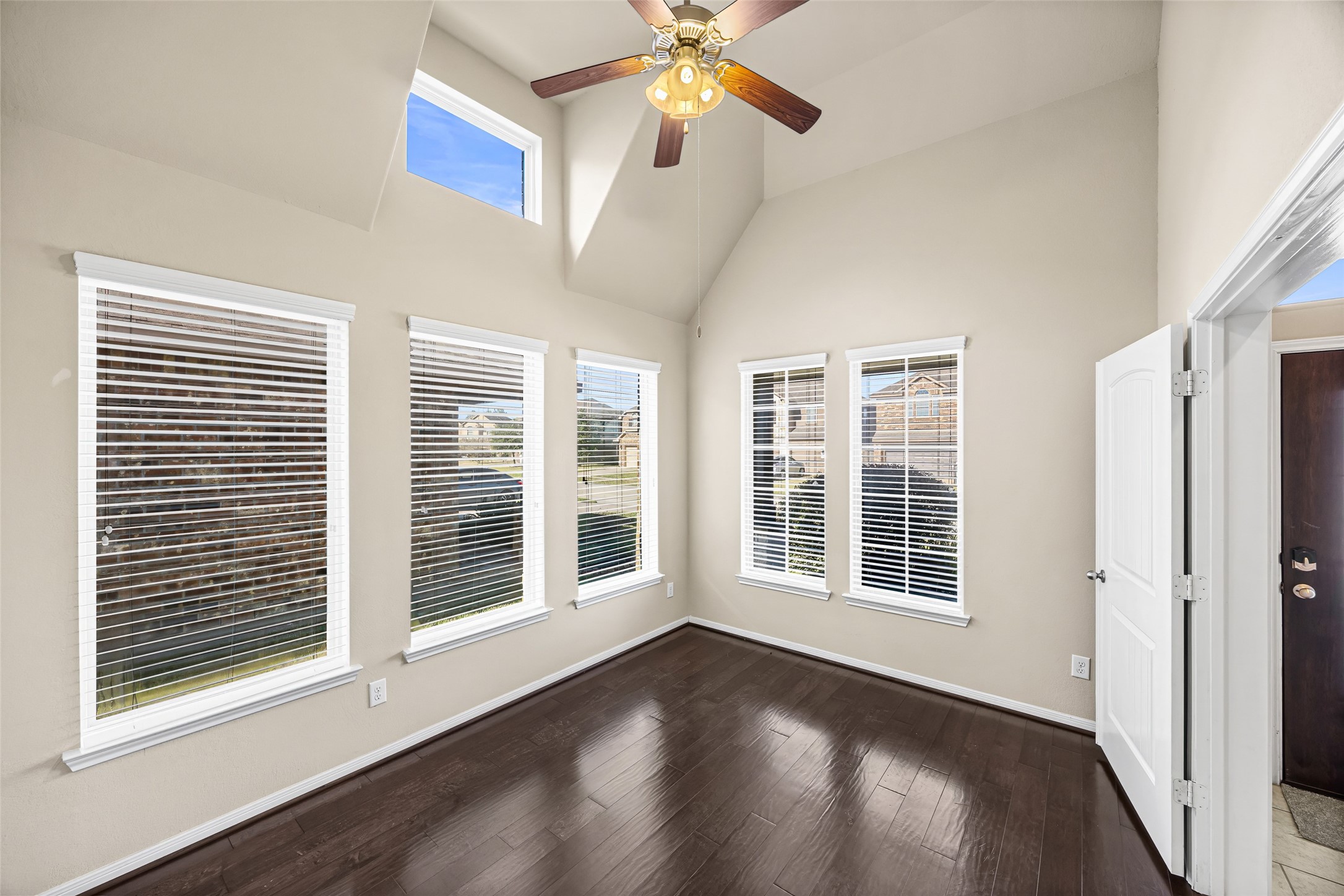 5615 Glenfield Spring Lane Spring, TX 77389 - Photo 6 of 28 a view of an empty room with a window and wooden floor