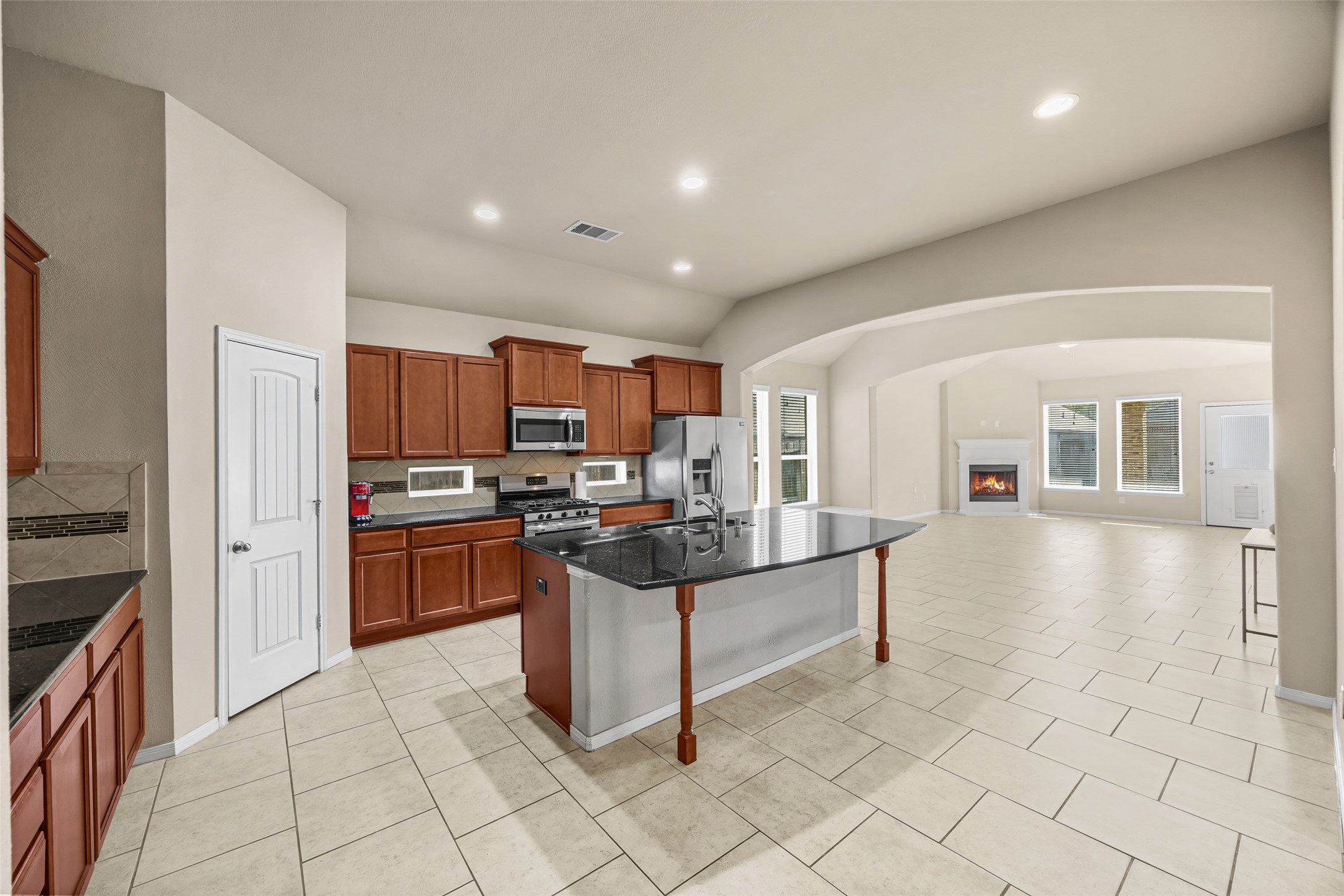 5615 Glenfield Spring Lane Spring, TX 77389 - Photo 8 of 28 a kitchen with stainless steel appliances kitchen island granite countertop a refrigerator and a stove top oven