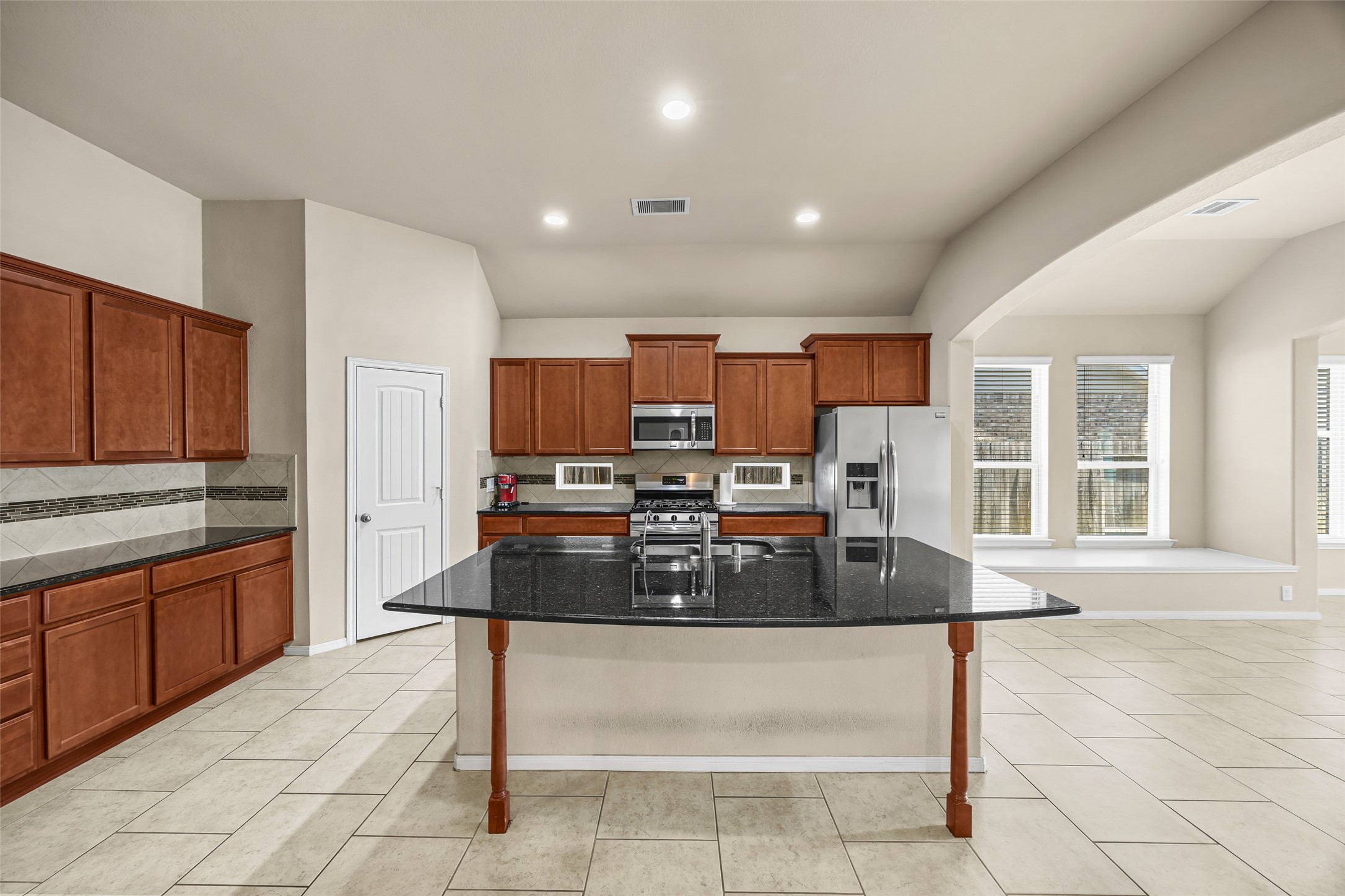 5615 Glenfield Spring Lane Spring, TX 77389 - Photo 9 of 28 a kitchen with stainless steel appliances granite countertop a stove and a sink