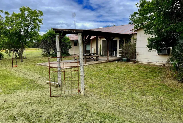 a view of a house with backyard porch and sitting area