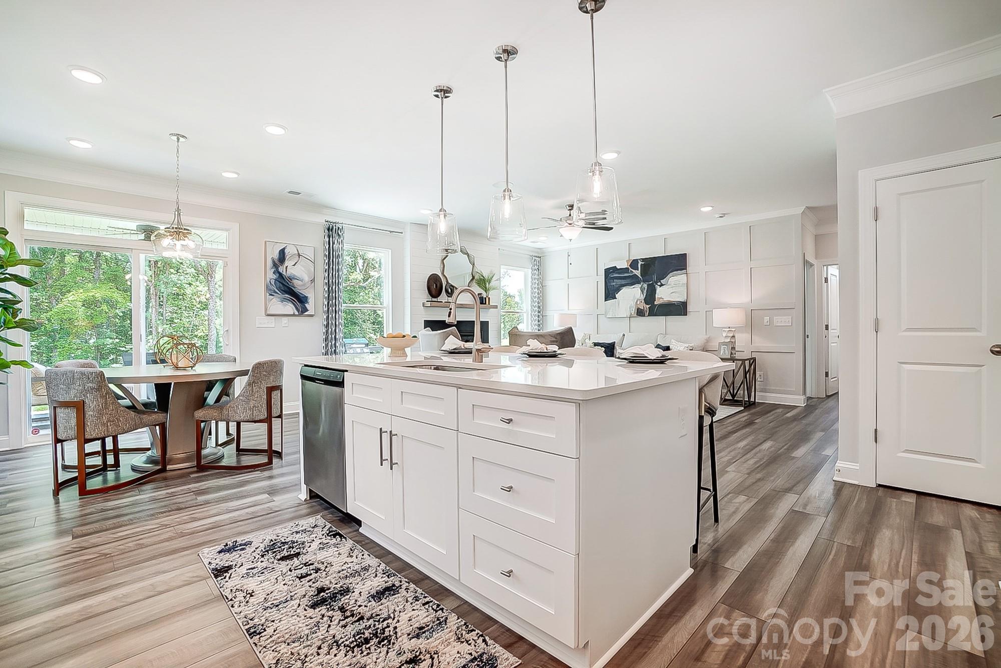 8615 Frank Grier Road Charlotte, NC 28215 - Photo 12 of 47 a kitchen with kitchen island granite countertop a sink cabinets and wooden floor
