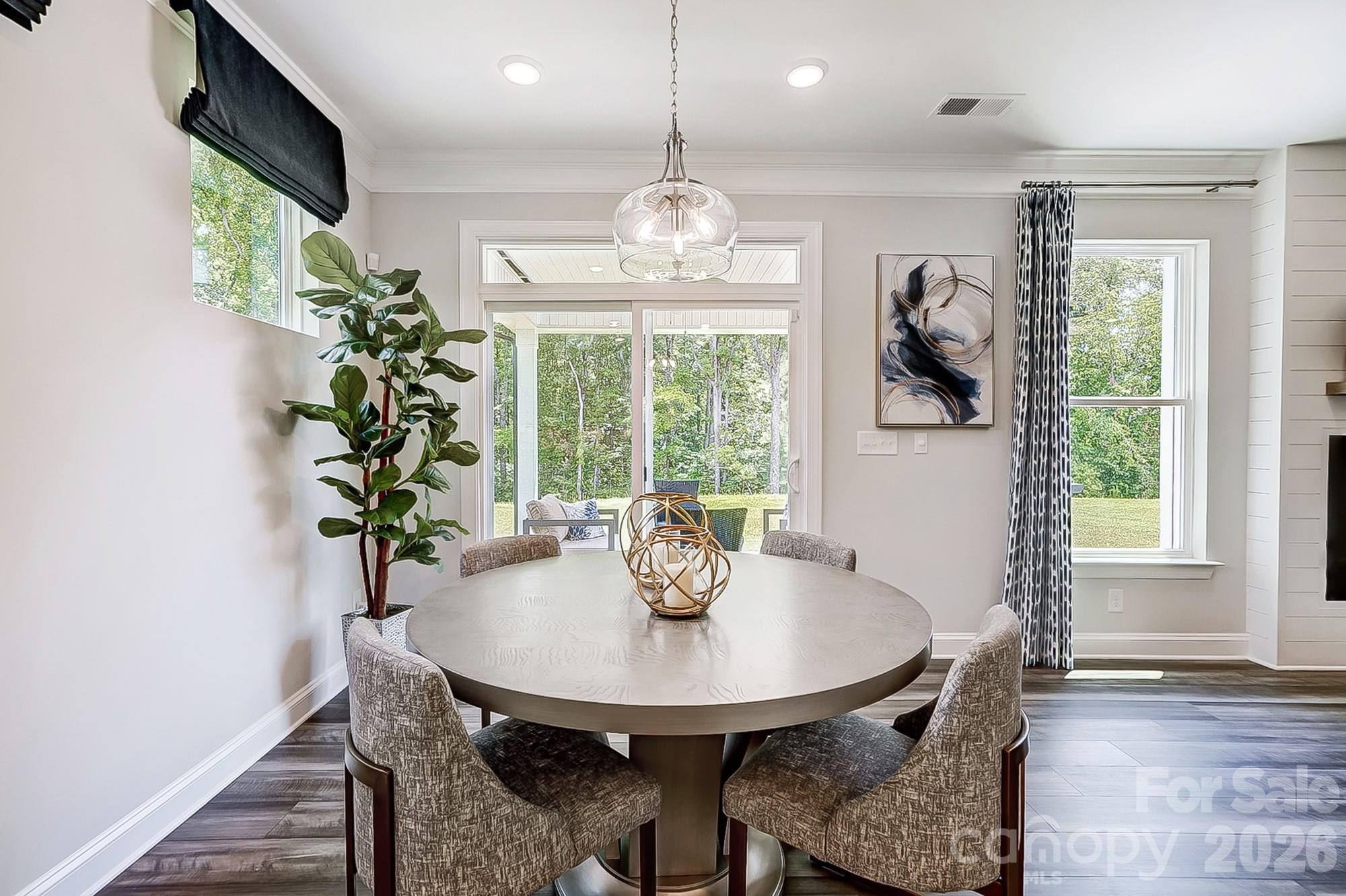 8615 Frank Grier Road Charlotte, NC 28215 - Photo 15 of 47 a view of a dining room with furniture window and wooden floor