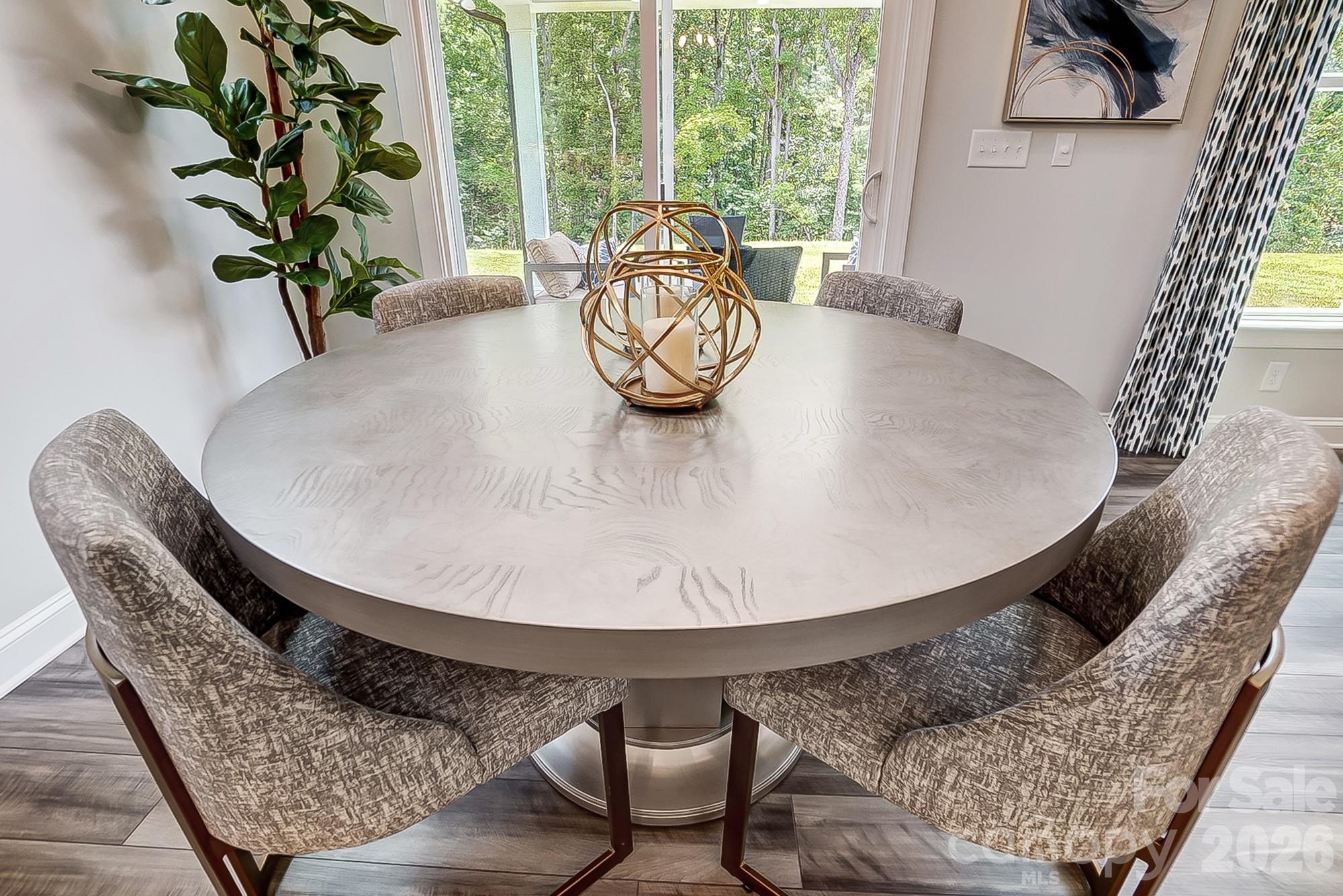 8615 Frank Grier Road Charlotte, NC 28215 - Photo 16 of 47 a view of a dining room with furniture and wooden floor
