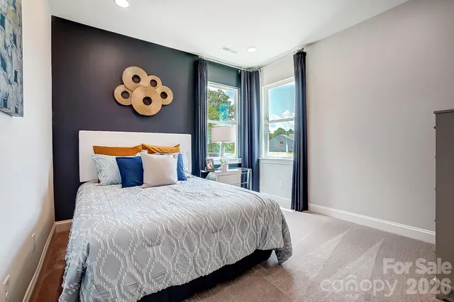 a bedroom with a large bed and a window