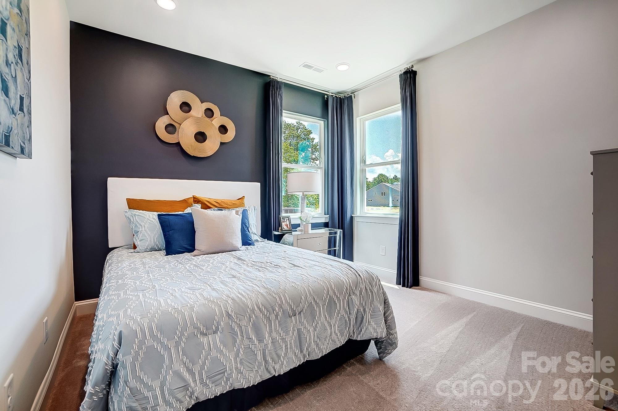 8615 Frank Grier Road Charlotte, NC 28215 - Photo 18 of 47 a bedroom with a large bed and a window