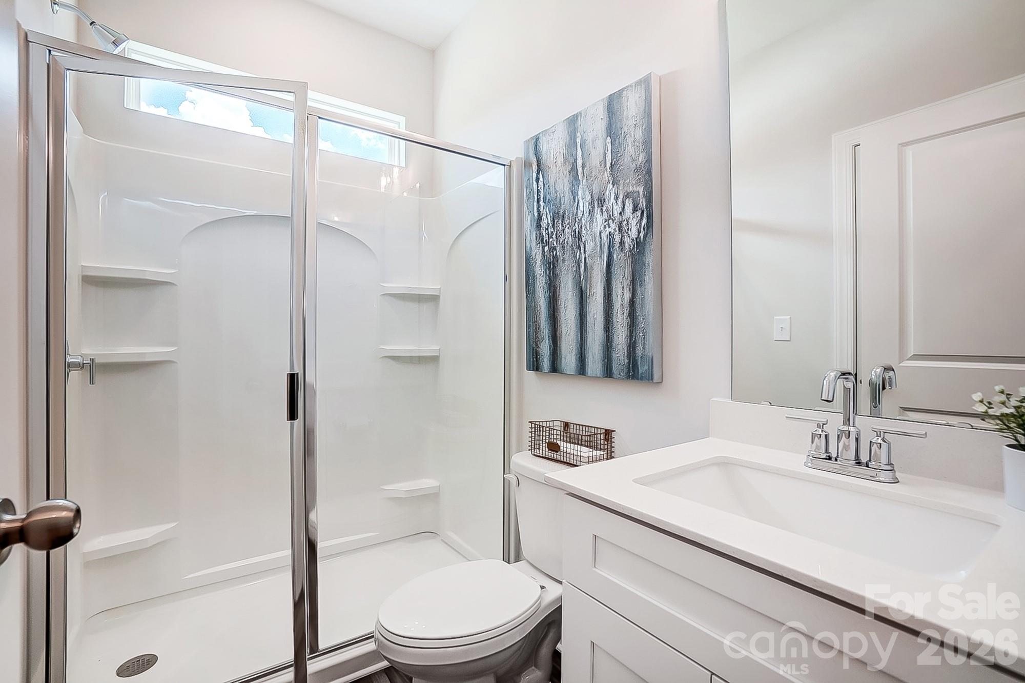 8615 Frank Grier Road Charlotte, NC 28215 - Photo 19 of 47 a bathroom with a granite countertop sink toilet and shower