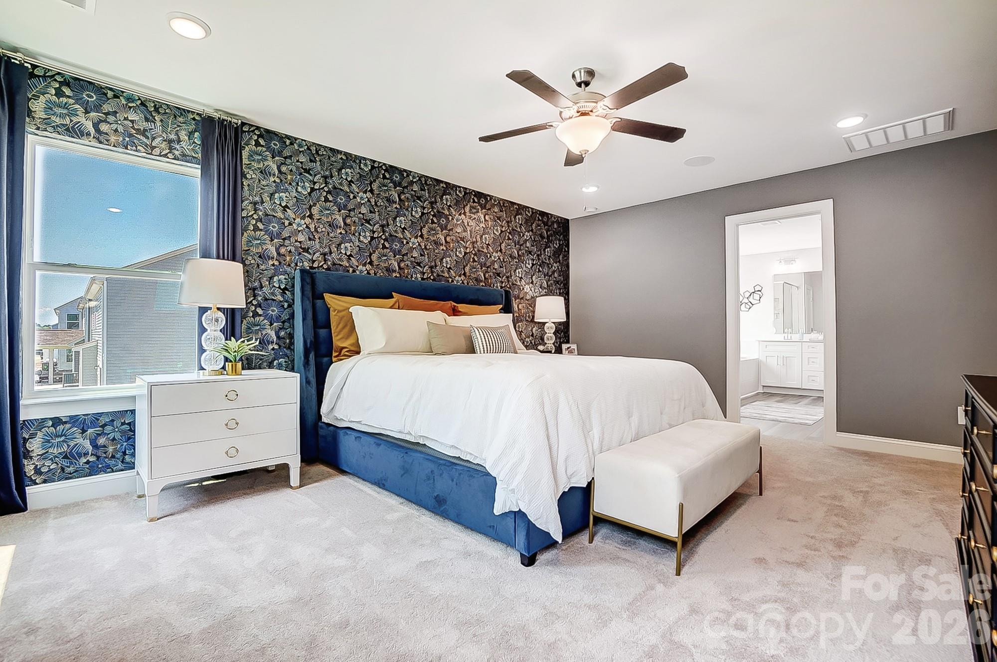 8615 Frank Grier Road Charlotte, NC 28215 - Photo 29 of 47 a bed room with a bed and a ceiling fan