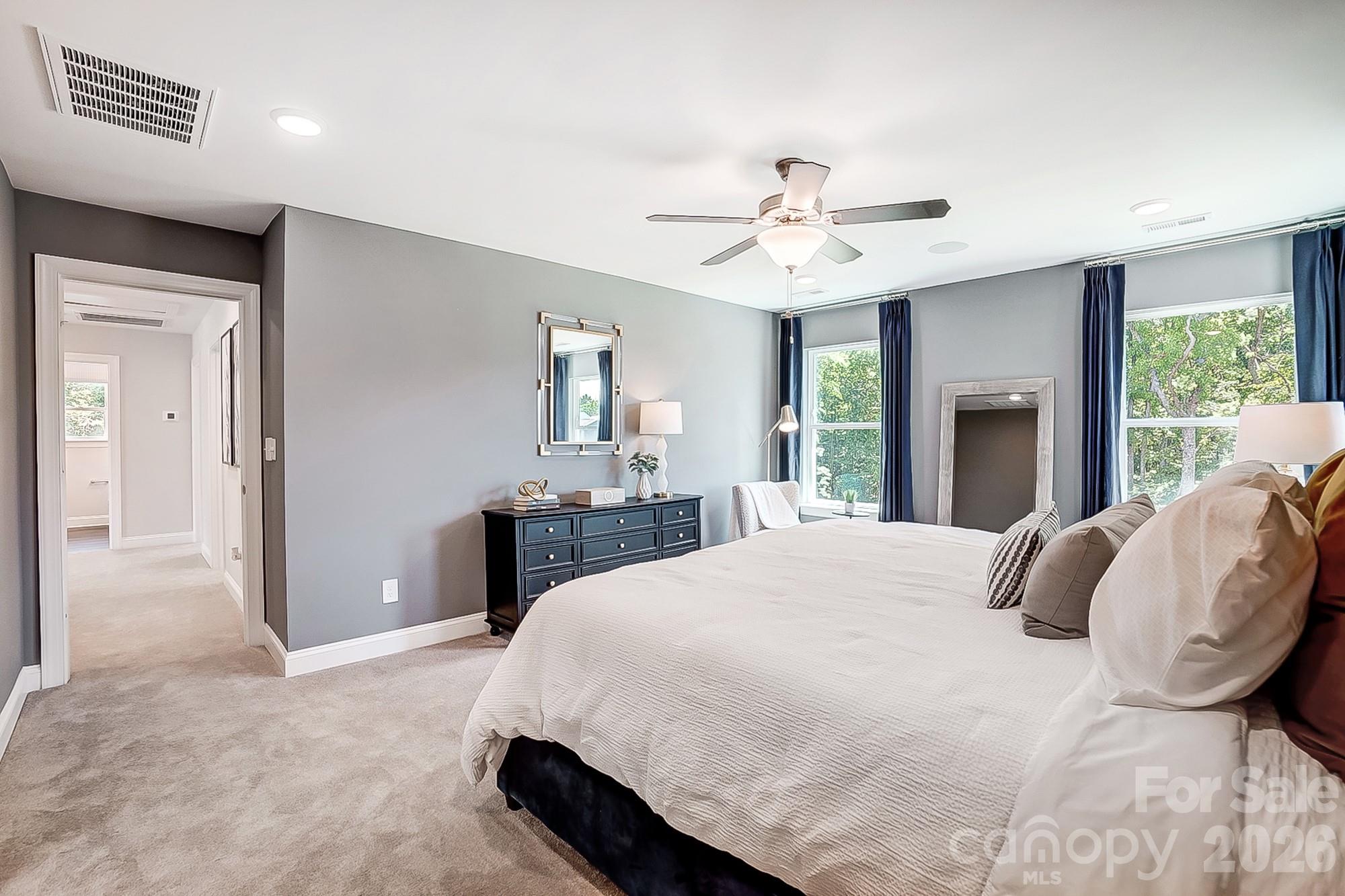 8615 Frank Grier Road Charlotte, NC 28215 - Photo 30 of 47 a bedroom with a large bed and a chandelier