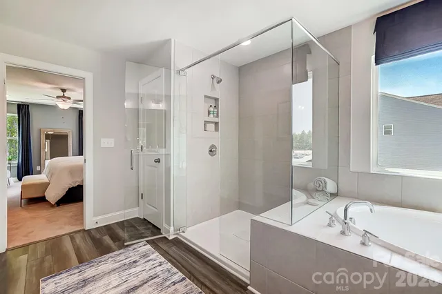 a spacious bathroom with a tub shower and sink
