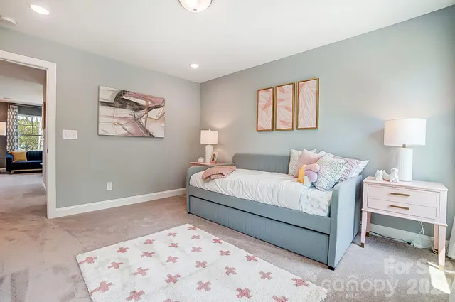 a bedroom with a bed and a painting on the wall