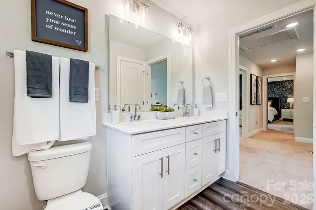 a spacious bathroom with a double vanity sink and a mirror