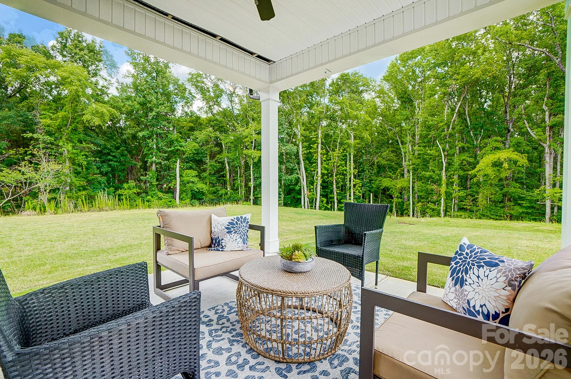 8615 Frank Grier Road Charlotte, NC 28215 - Photo 43 of 47 a view of a patio with couches potted plants and ocean view