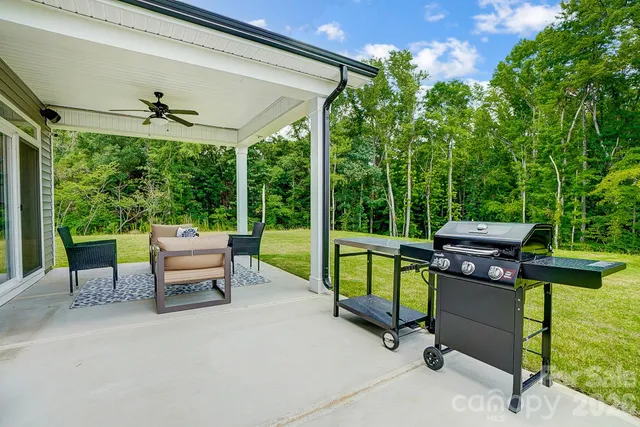 a view of a patio with a table chairs and a backyard