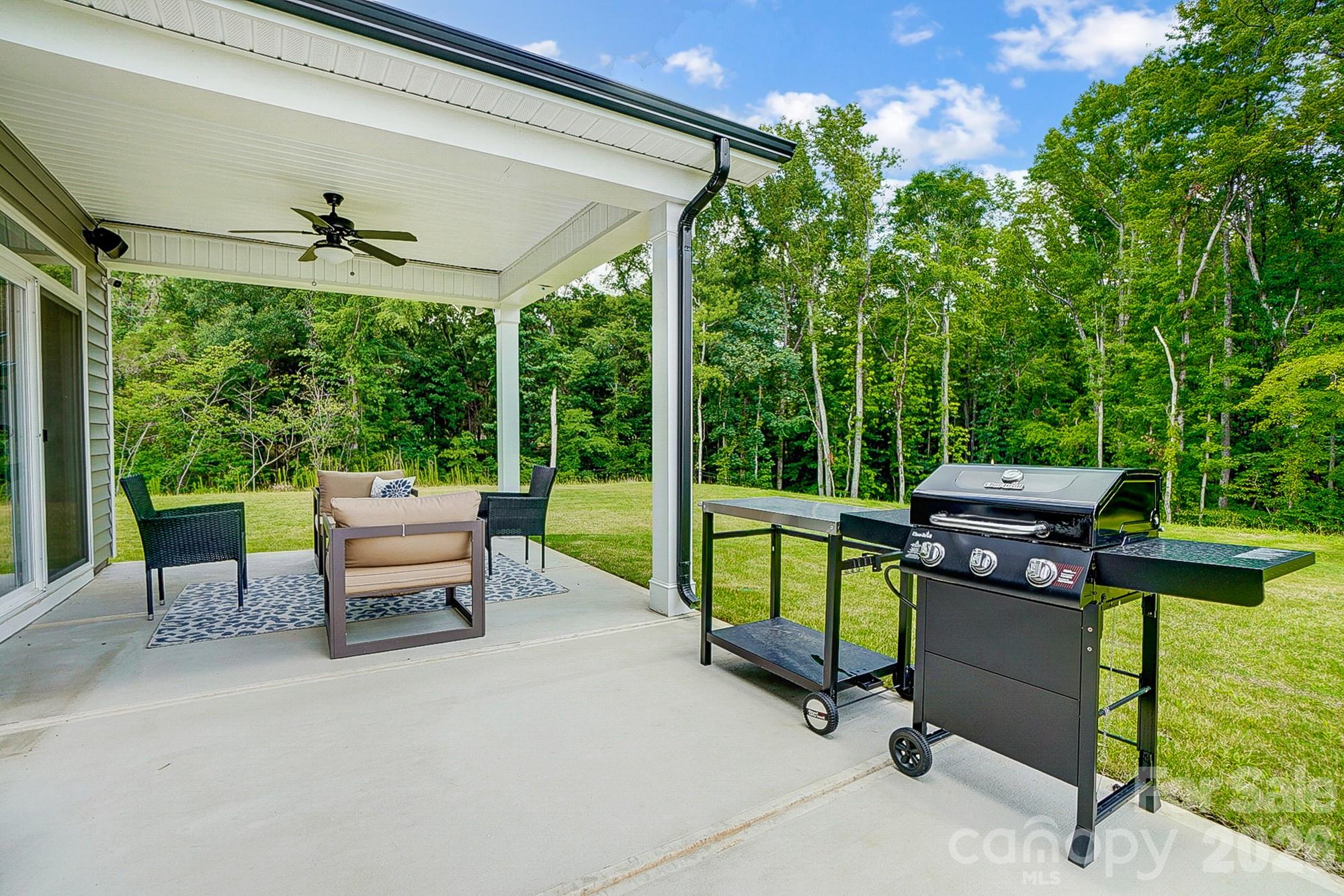 8615 Frank Grier Road Charlotte, NC 28215 - Photo 44 of 47 a view of a patio with a table chairs and a backyard