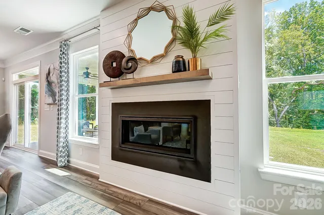 a living room with a fireplace and a large window