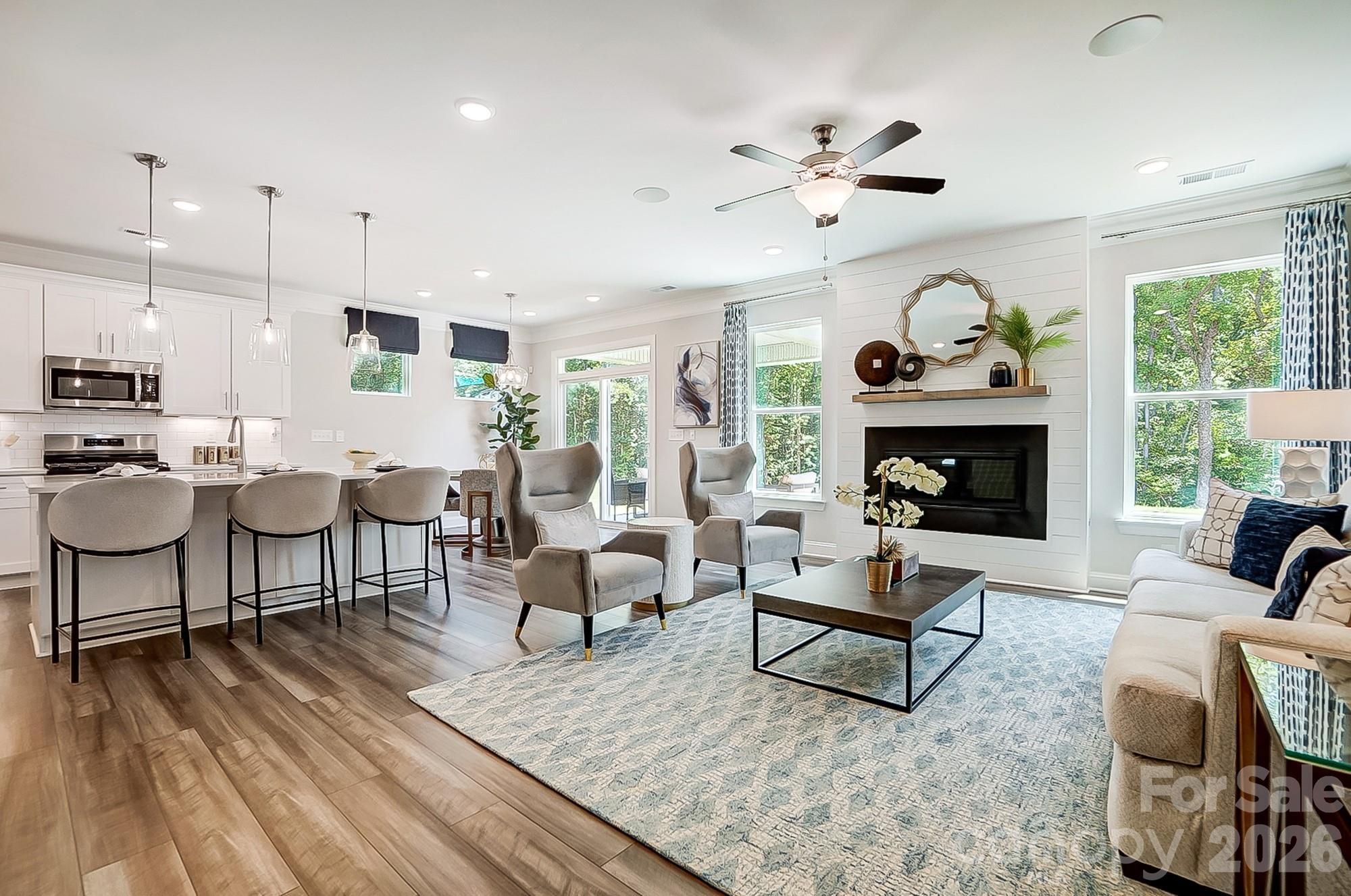8615 Frank Grier Road Charlotte, NC 28215 - Photo 7 of 47 a living room with furniture a fireplace and a large window