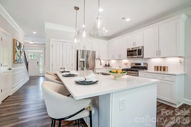 a kitchen with refrigerator cabinets and dining table