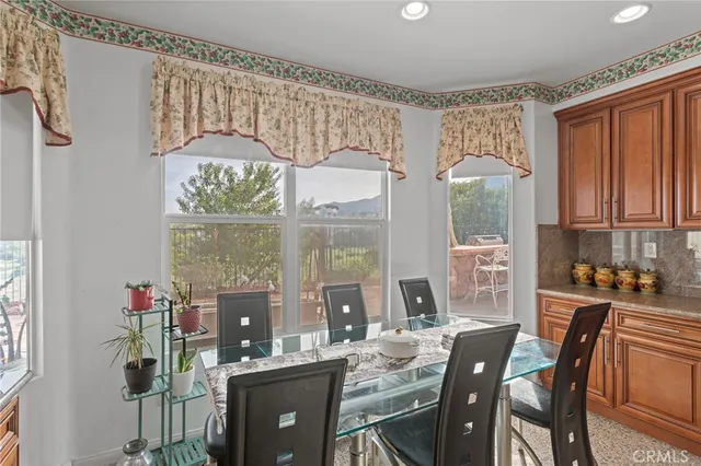 a dining room with furniture a chandelier and window