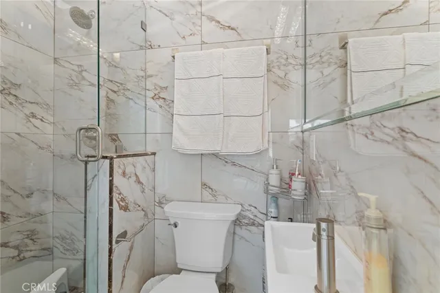 a bathroom with a toilet and shower