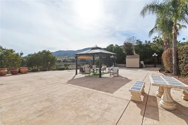a view of patio with a table and chairs under an umbrella