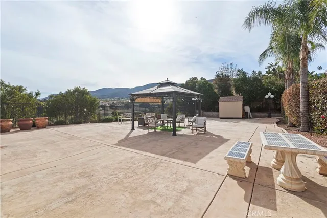 a view of patio with a table and chairs under an umbrella