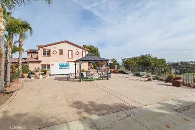 a view of a street with a building and couple of cars parked in front of it