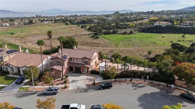 an aerial view of a houses with a yard