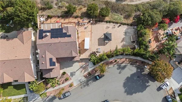 an aerial view of a house with a yard and lake view
