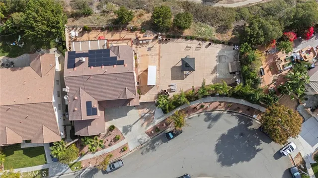 an aerial view of a house with a yard and lake view