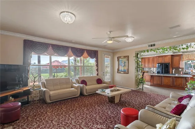 a living room with furniture and a floor to ceiling window