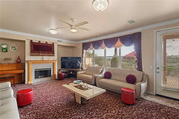 a living room with furniture a fireplace and a window