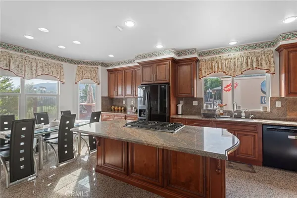 a kitchen with lots of counter top space and painting on the wall