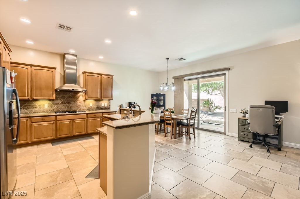 7513 Java Sparrow Street North Las Vegas, NV 89084 - Photo 13 of 36 Kitchen with exhaust hood, backsplash, stainless s