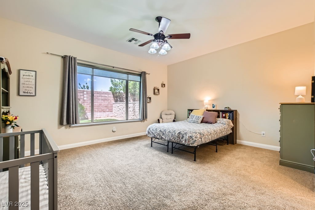 7513 Java Sparrow Street North Las Vegas, NV 89084 - Photo 14 of 36 Bedroom featuring carpet floors, a ceiling fan wit