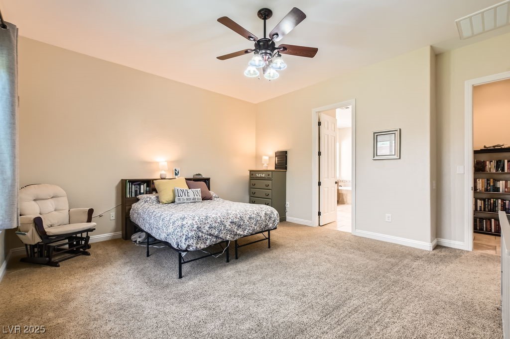 7513 Java Sparrow Street North Las Vegas, NV 89084 - Photo 15 of 36 Bedroom featuring a ceiling fan, ensuite bath, and