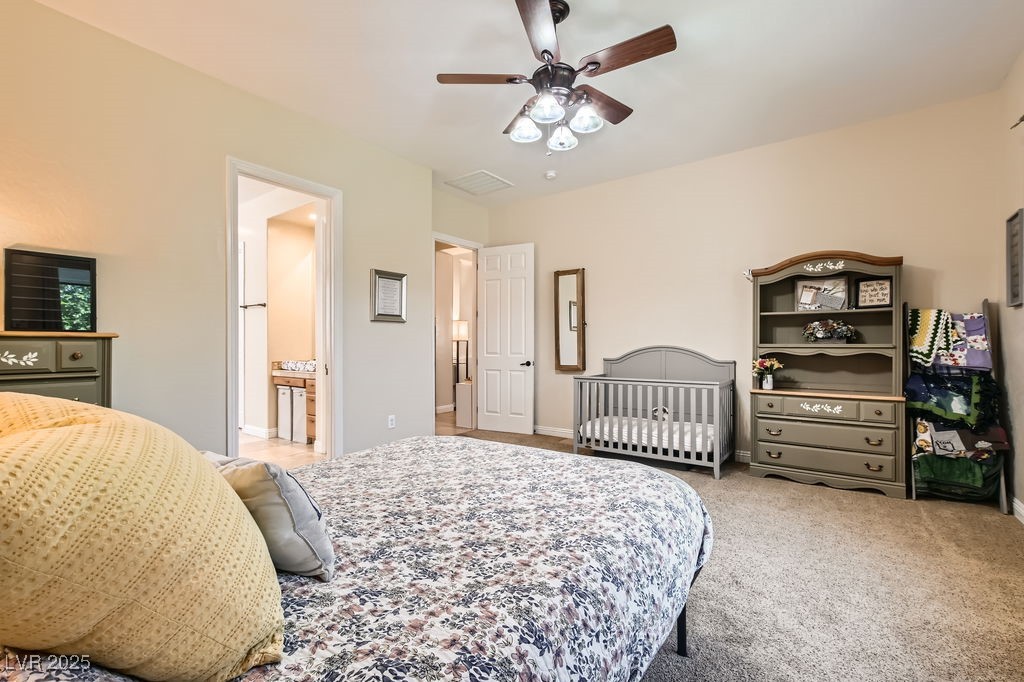 7513 Java Sparrow Street North Las Vegas, NV 89084 - Photo 16 of 36 Bedroom featuring light carpet, a ceiling fan, and