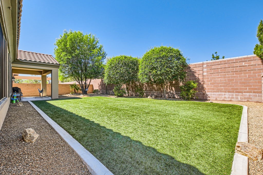 7513 Java Sparrow Street North Las Vegas, NV 89084 - Photo 25 of 36 View of yard featuring a fenced backyard and turf