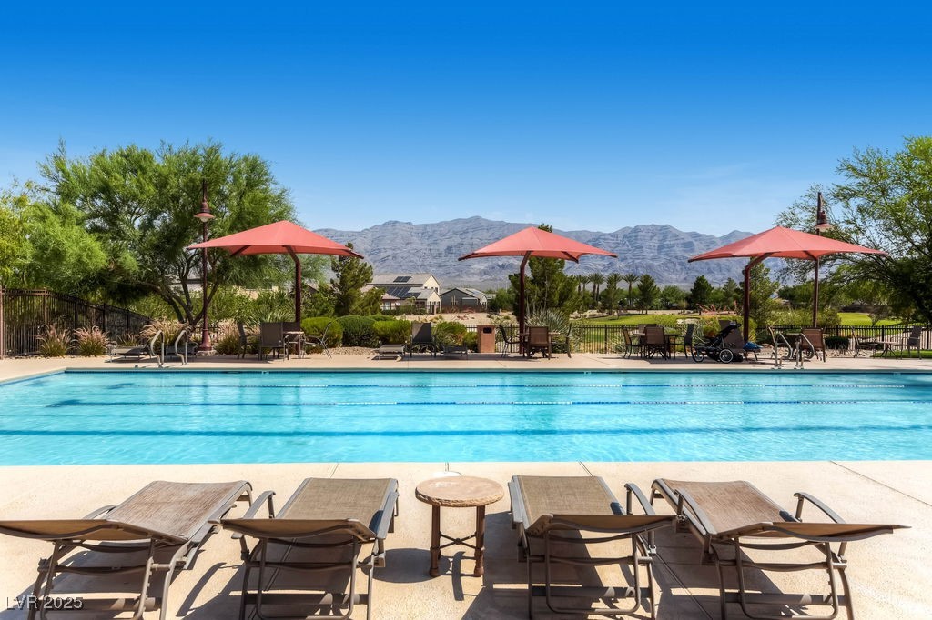 7513 Java Sparrow Street North Las Vegas, NV 89084 - Photo 33 of 36 Pool featuring a patio area, fence, and a mountain