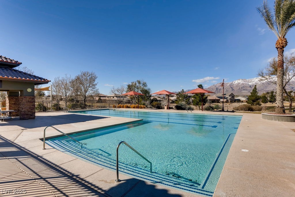 7513 Java Sparrow Street North Las Vegas, NV 89084 - Photo 34 of 36 Pool with a patio, fence, and a mountain view