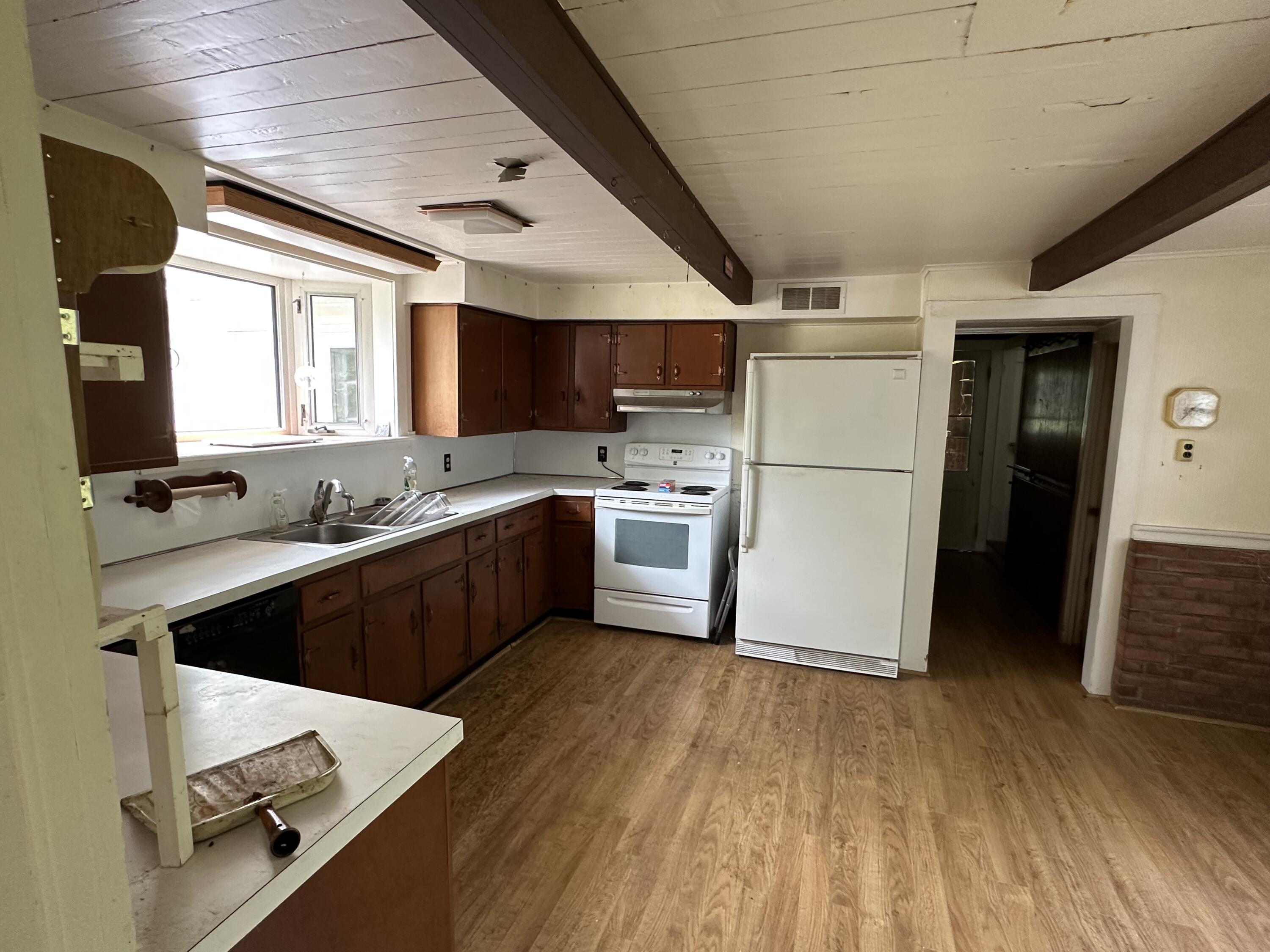 337 Summit Road Swiftwater, PA 18370 - Photo 24 of 35 a kitchen with a refrigerator a stove a sink dishwasher and a oven with wooden floor