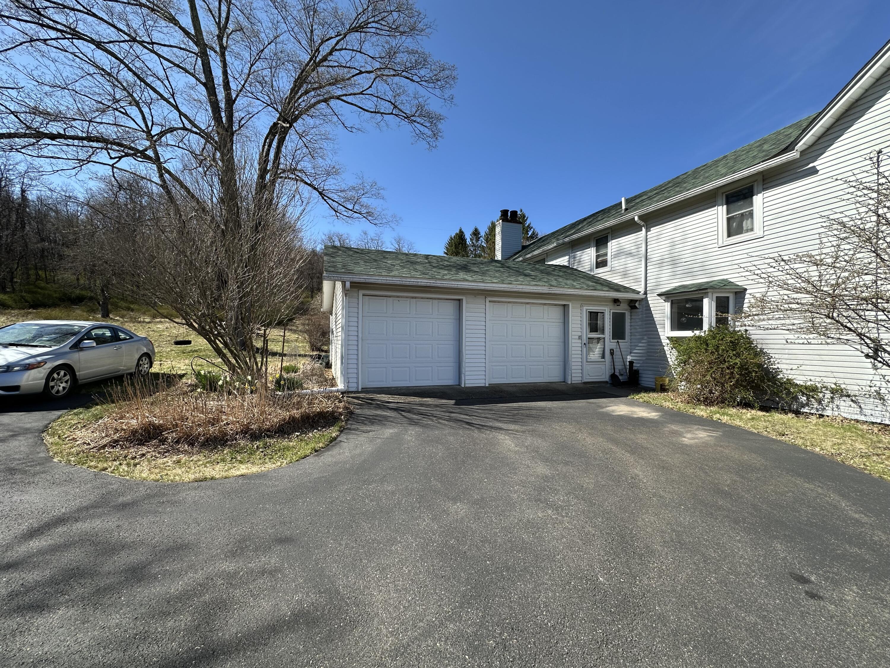 337 Summit Road Swiftwater, PA 18370 - Photo 3 of 35 a view of a house with a yard and garage