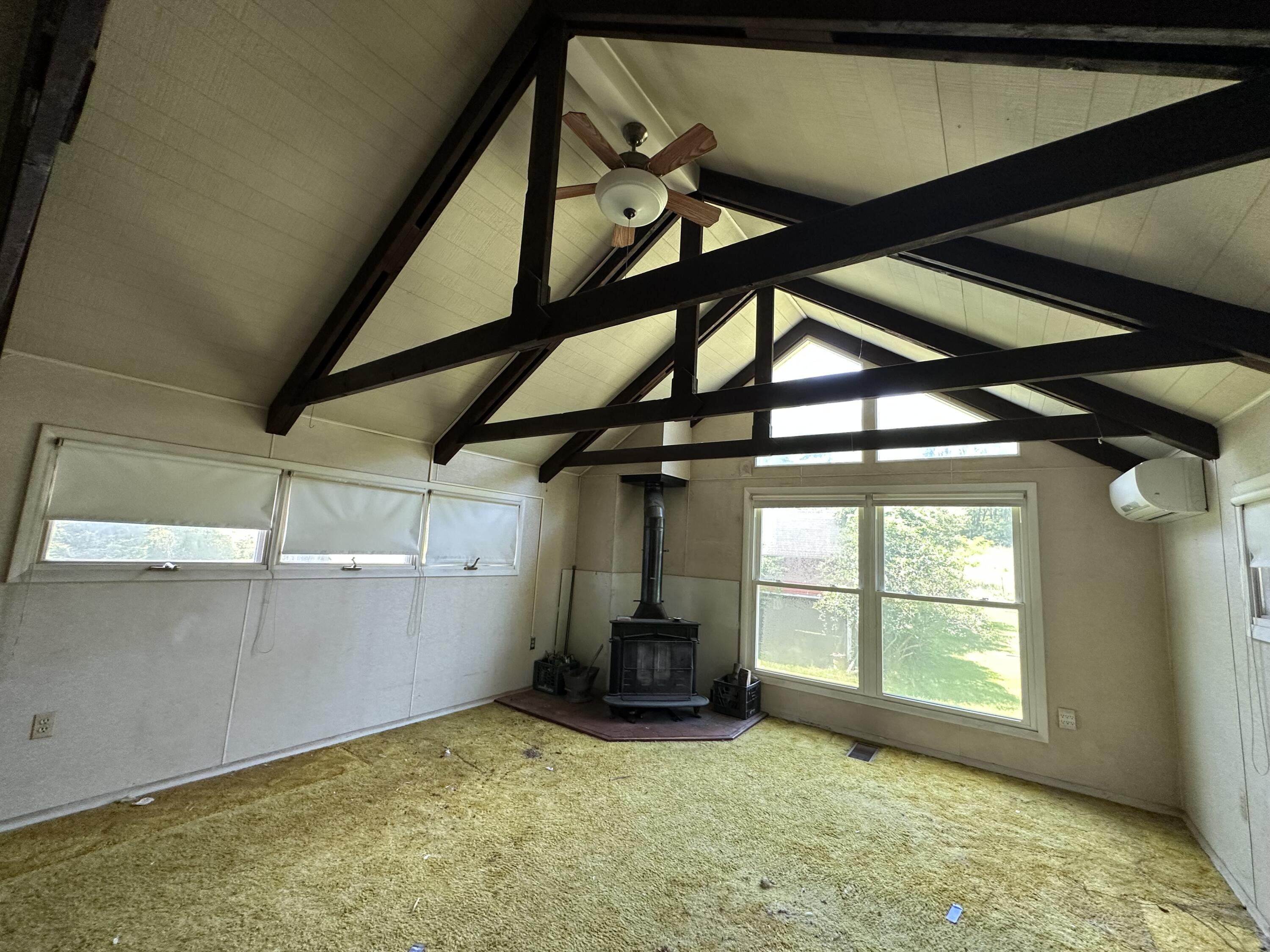 337 Summit Road Swiftwater, PA 18370 - Photo 34 of 35 a view of an empty room with a fireplace and windows