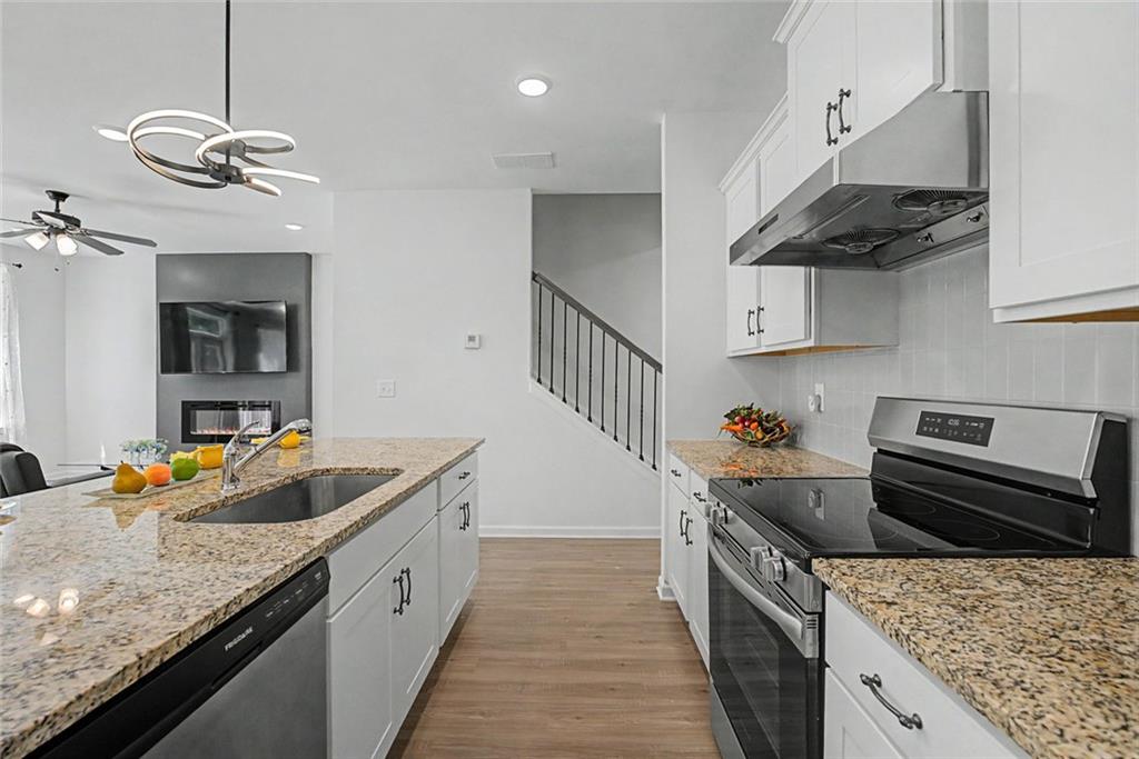 2310 Portrush Way Southeast Atlanta, GA 30339 - Photo 12 of 38 a kitchen with stainless steel appliances granite countertop a sink stove and refrigerator