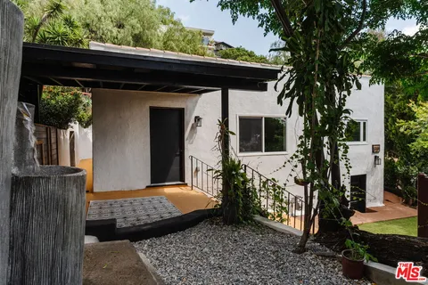 a kitchen with granite countertop white cabinets white appliances and sink